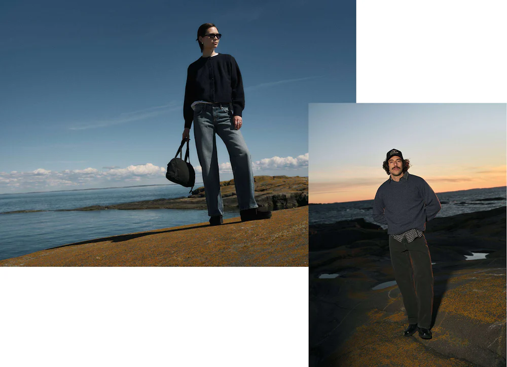 Kvinne i mørk cardigan og jeans med veske på klippe ved havet. Mann i grå genser og caps ved solnedgang over havet.