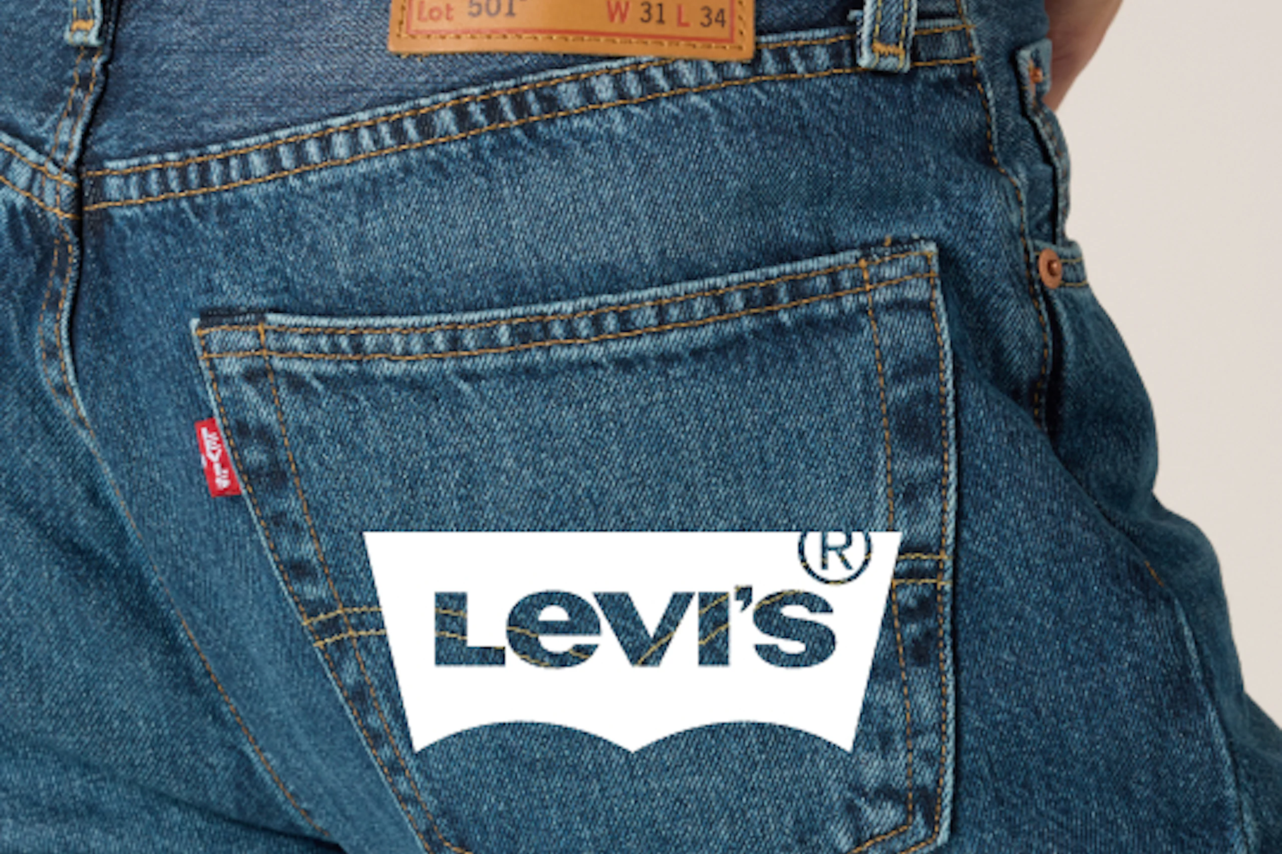 Nærbilde av baksiden av Levi's 501 mellomvasket blå jeans som viser lærmerket og baklommen.